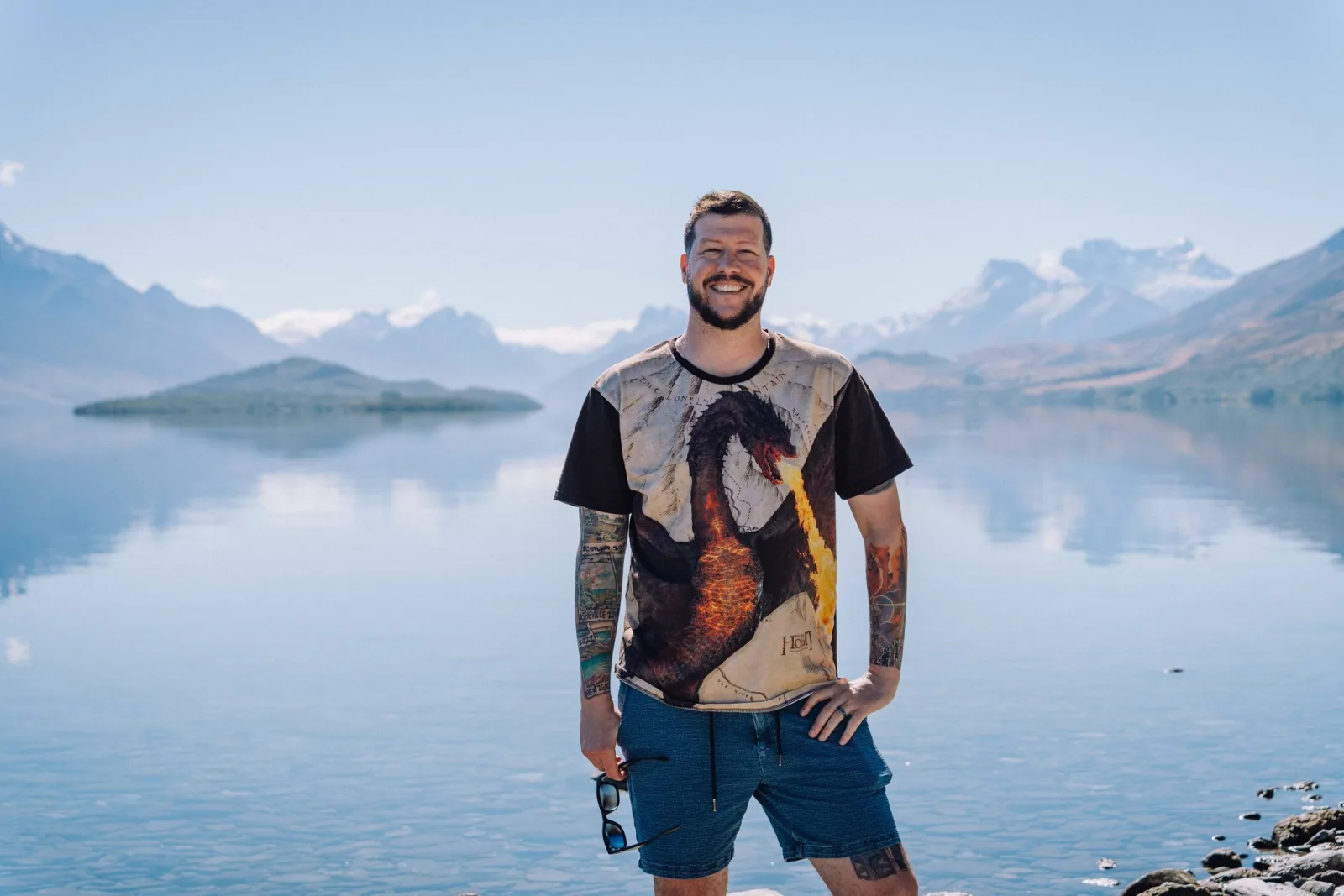 Patrick Casale standing beside a mountain lake in a Lord of the Rings T-shirt
